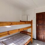 Side view of bunk beds and wardrobe in 2-sleeper dorm room at Ballito Backpackers.