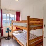 Close-up of wooden bunk beds in Ballito Backpackers' dorm room