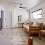 Living area with seating in Ballito Backpackers' semi self-catering 8-sleeper dorm room.