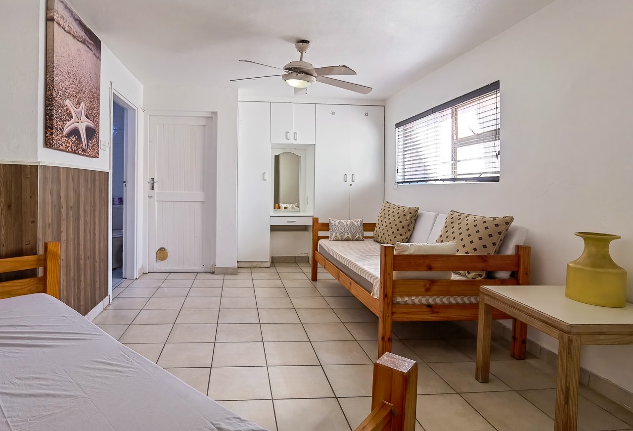 Living area with seating in Ballito Backpackers' semi self-catering 8-sleeper dorm room.