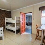 Kitchenette and dining area in the semi self-catering 6-sleeper dorm room at Ballito Backpackers